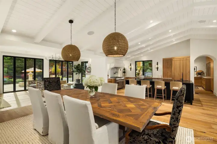 Dining/kitchen area features tongue and groove ceilings.  Custom cabinetry features integrated Thermador appliances.  Thermador dishwasher plus a second Fisher Paykel two-drawer dishwasher.  Uline built-in ice maker.  Sharp microwave is built-in into the island.  Vent hood over the Thermador range is Venetian plaster.  Separate pantry with built-in freezer.