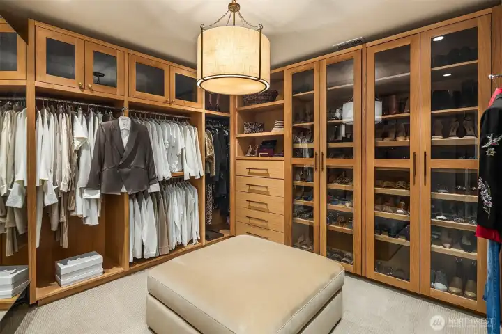 Two primary closets.  One featuring custom white oak cabinetry.  Second primary closet features a second washer and dryer.