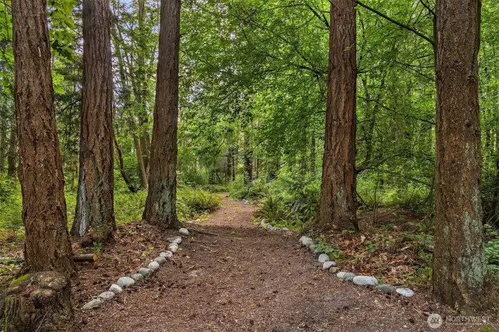 Five acres of woods with walking trails, platform for target practice, and a special hobbit hut.