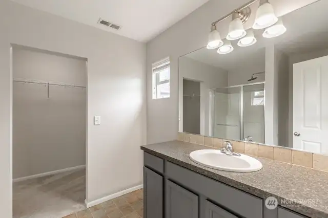 The primary bath has a large shower and a walk-in closet.