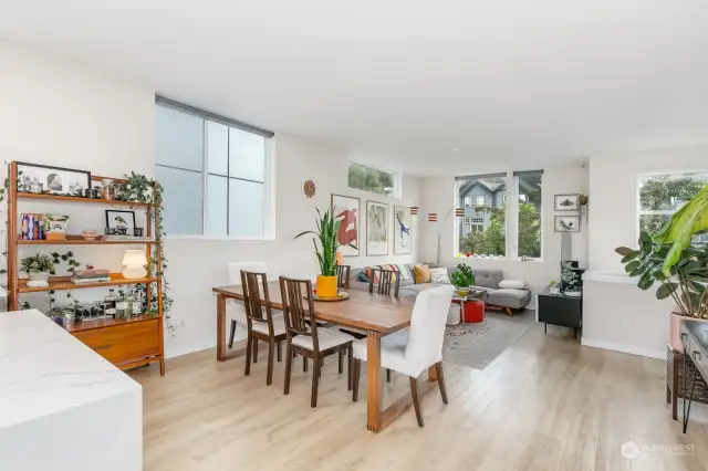 Large windows with custom blinds and tall ceilings make this a lovely open space