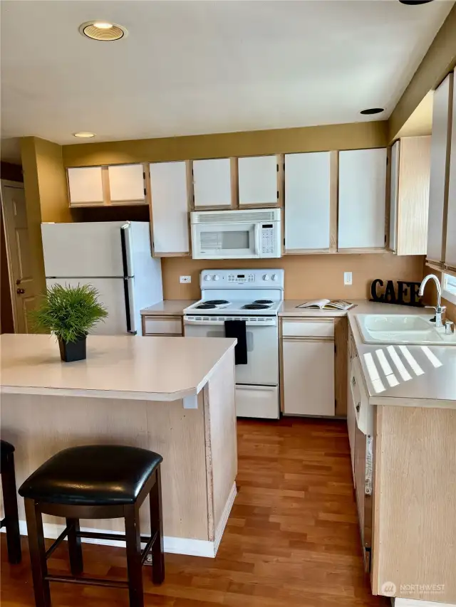 Plenty of cabinet and counter space. Kitchen sink window looks west, to the territorial view.