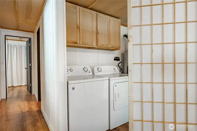 Laundry area with cupboard storage.