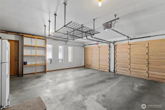 Large 2 Car Garage with Storage Space and Door to the Exterior.