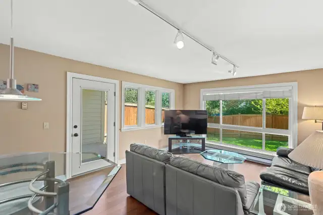 Living Room has lots of windows with green views of trees and yard