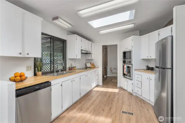 Large kitchen has plenty of cabinets and counterspace for your needs. BRAND NEW STAINLESS APPLIANCES including: dishwasher, fridge, wall oven, cooktop, and built-in microwave over the oven.
