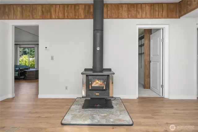Showing the location of the wood stove. Living room is on the left and the 1st bedroom is on the right.