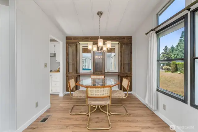 Dining room and built-ins with cabinet lighting and mirrors.