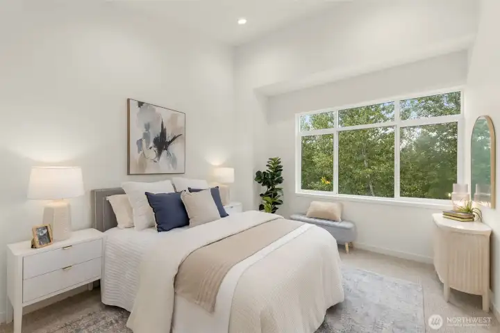 Sun-filled primary suite offers a peaceful retreat with treetop views and space to unwind.