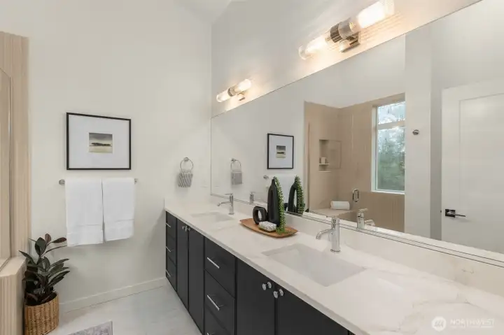 Double vanities, custom mirrors, and a calm color palette create the perfect spa-inspired start (or end) to your day.