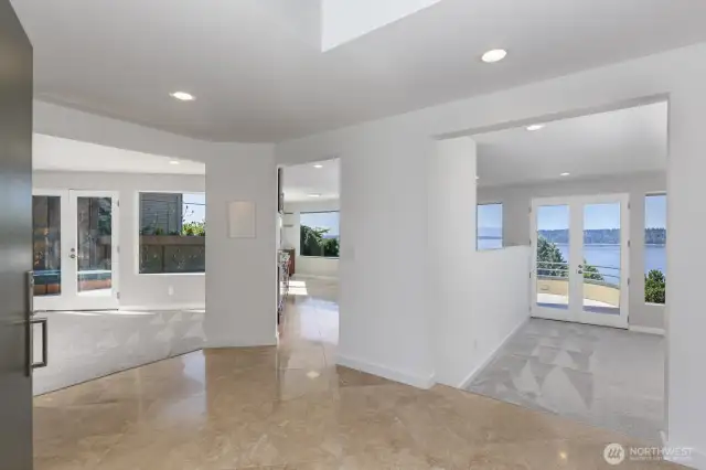 As you enter you see the views with the famil room on the left, the entry to the kitchen and then the living room straight ahead. Light and bright. Freshly painted, all new carpet and Travertine tiling.