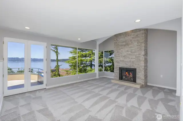 Enjoy warm and cozy evenings in front of the gas fireplace with floor to ceiling stone. Note the high ceilings and large windows to capture the view.