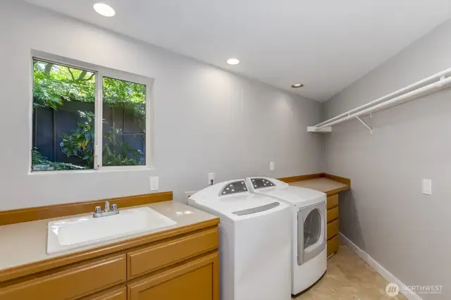The full size utility room has plenty of counter space and lots of light.