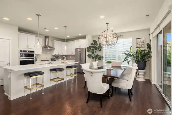 Chef's kitchen with enormous island, high quality cabinets, stainless steel appliances connect to the entertainment size dining room