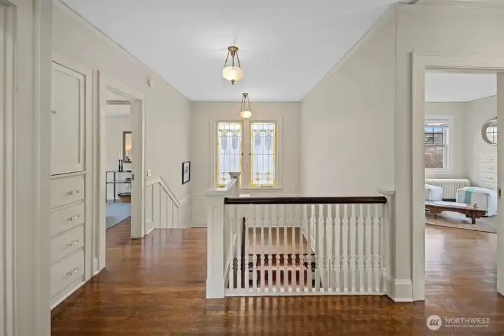 Each of the four bedrooms and the upstairs bath open onto the spacious and bright second-floor landing. Wake to sunlight streaming through the stained glass.