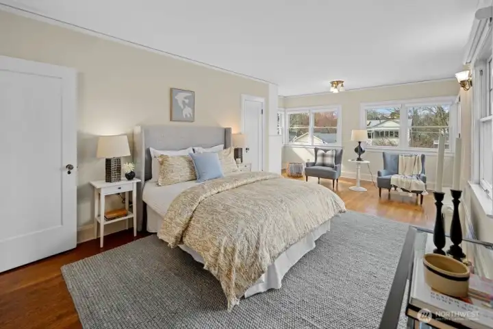 Spacious primary bedroom with west and north facing windows