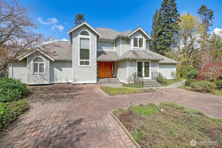 Home with courtyard entrance on the east side overlooking the brick courtyard.  Notice the double glass doors  this is the office/den area.  Imagine writing the next BEST seller from this room.