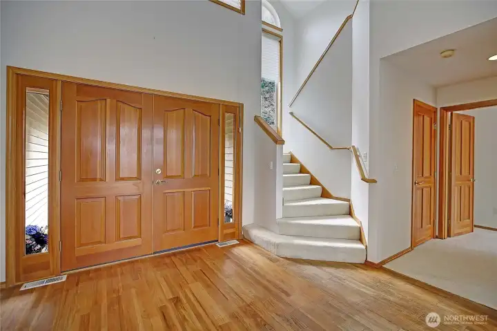 Large entry as you come in to the primary bedroom and up the stairs to the upper level, loft, full bath, sunroom and additional bedroom.