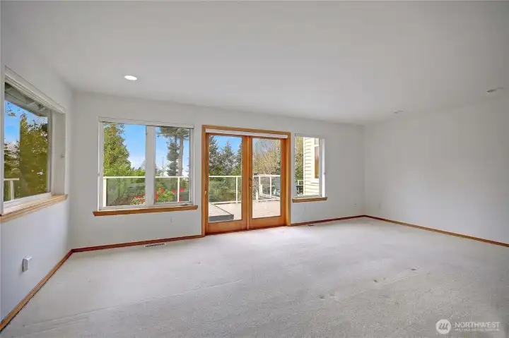 Primary bedroom is very roomy, opening onto deck.