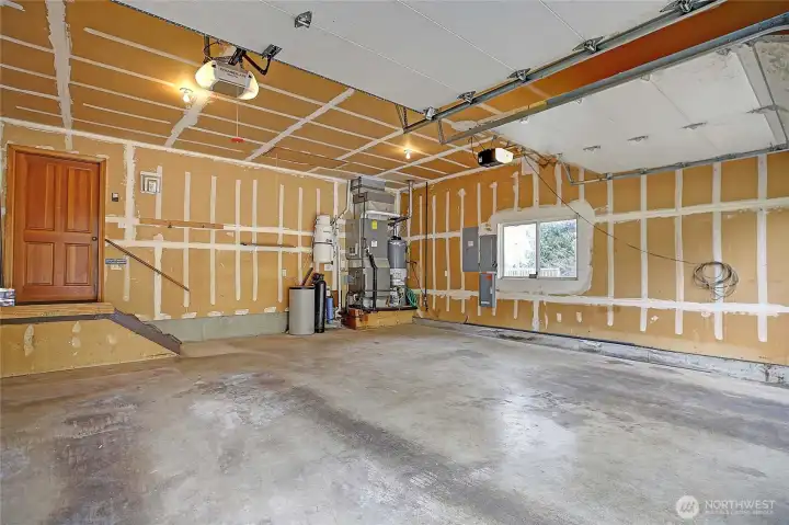 Garage with entry into main level off utility room.  Water softener, vac system, generator panel, nice  roomy garage.