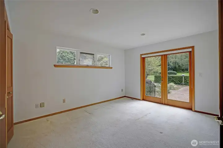 Office space/den/reading room on main level opens with double glass doors to brick courtyard.