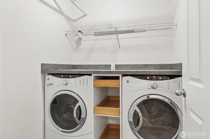 Upstairs laundry (Brilliant!) with included washer & dryer, pull out drawers and hanging racks.