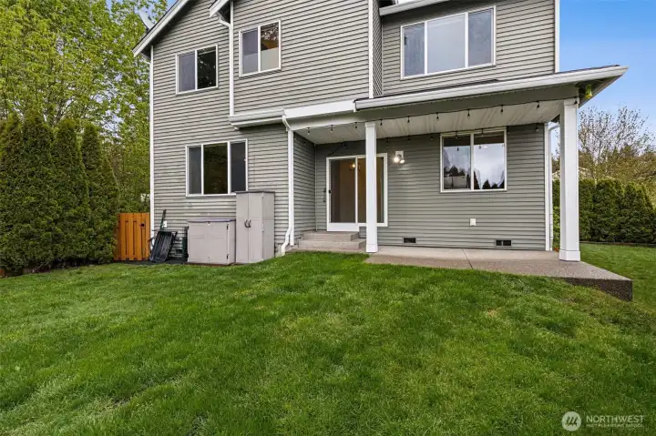 View of the rear of the home from the backyard, fully-fenced and only one neighbor! Nice patio for entertaining.