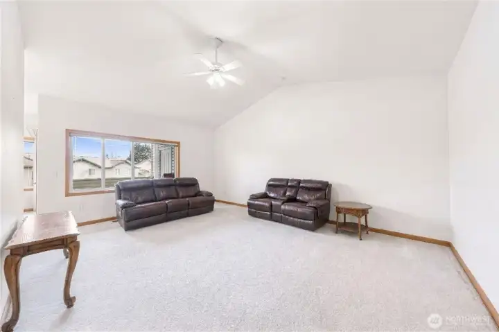 Open Living Area with Large Window and  Flexible Layout - Virtually Decluttered