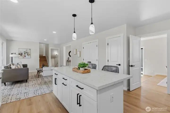 Kitchen and living room lead into the dining room and additional family room. Kitchen and living room lead into the dining room and additional family room.