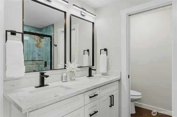Main bath double sinks, mirrors, quartz countertops and private room. Main bath double sinks, mirrors, quartz countertops and private room.
