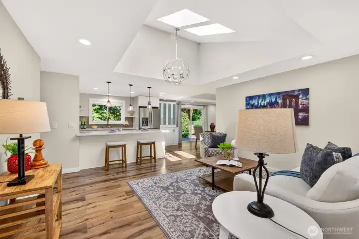 Vaulted ceilings and dual skylights flood the open living space with natural light, while the flow into the kitchen and its breakfast peninsula, then out to the backyard slider, makes everyday living and entertaining effortless.