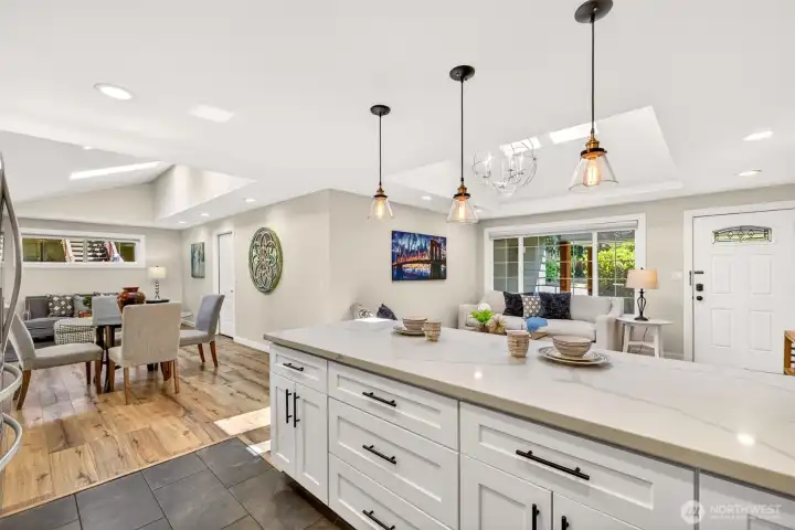 The peninsula opens directly to the dining and living areas, keeping conversation flowing whether you are plating dinner or welcoming guests near the front entry.