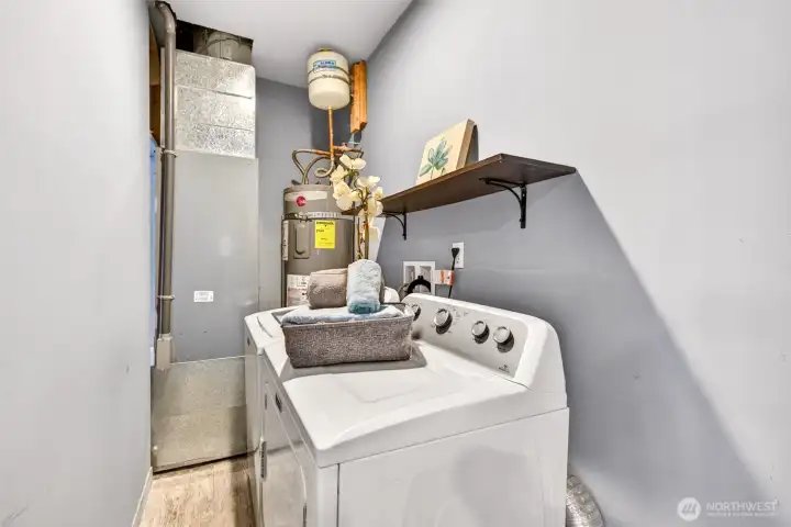A dedicated laundry and utility space keeps the washer and dryer tucked neatly out of the main living areas for easy day-to-day function.