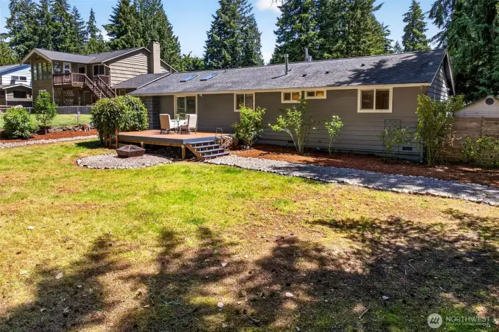 This single-level home opens to an expansive fenced yard with a storage shed and mature landscaping, delivering both space and seclusion in a sought-after Juanita Hills setting.