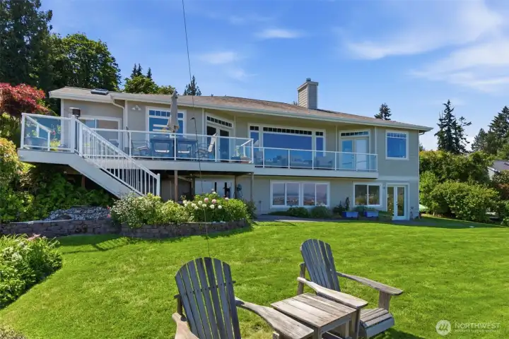 MAIN HOUSE - back side of home facing water and mountains with expansive lawn.