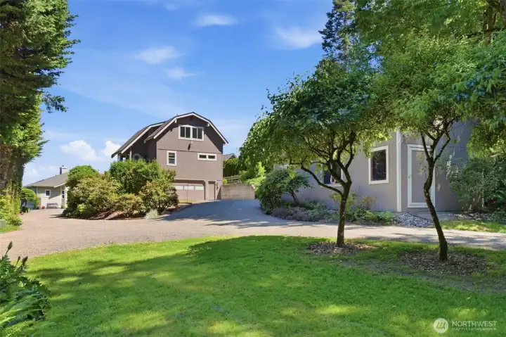 Shy acre lot with lawns, landscaping and garden.