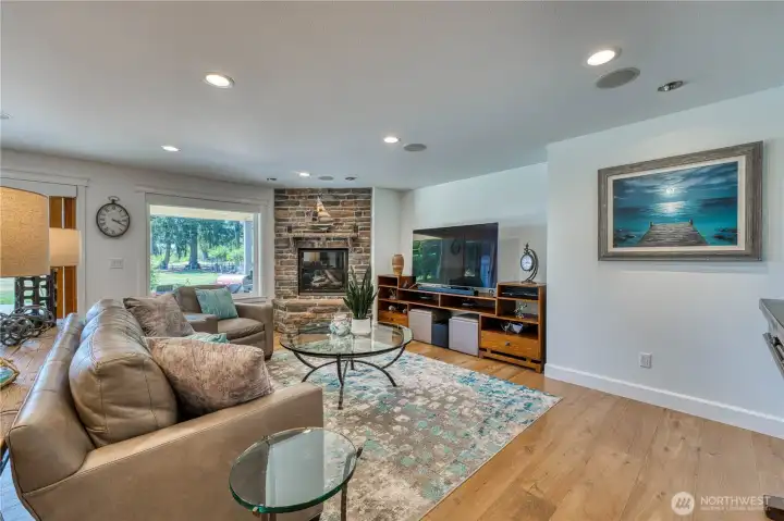 The kitchen flows seamlessly to the family room which overlooks the covered patio and has glimpses of the Sound.