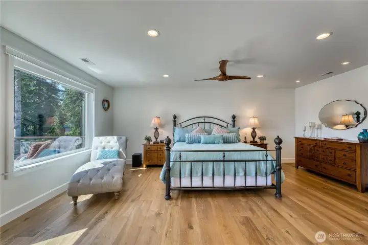 Primary bedroom is a comfortable retreat, with engineered hardwoods and lots of light.