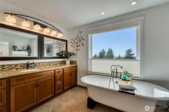 Free standing soaking tub with extra large vanity and dual mirrors and heated tile floors.