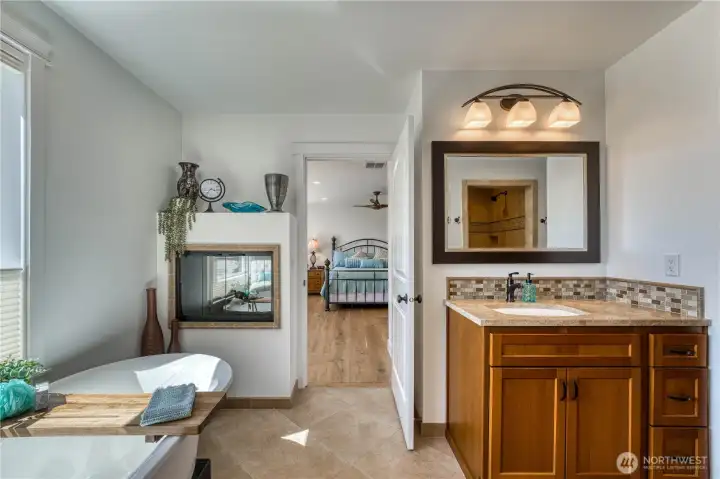 Primarey bath features dual vanities and an electric fire place for ambience while soaking in the tub.