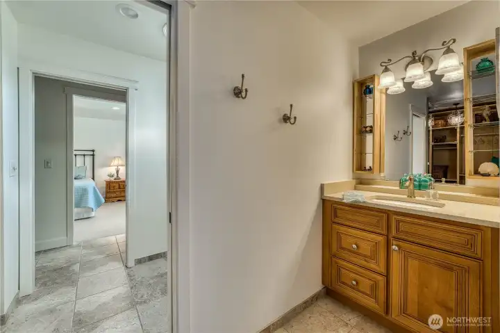 Two bedrooms share a jack and jill bath, each with their own vanity and separate closets.