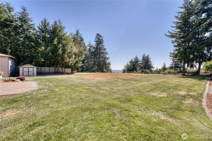 Some much flat yard with ample space to install a pool. New septic was installed in 2009 making space for a pool just off the patio if you wanted.