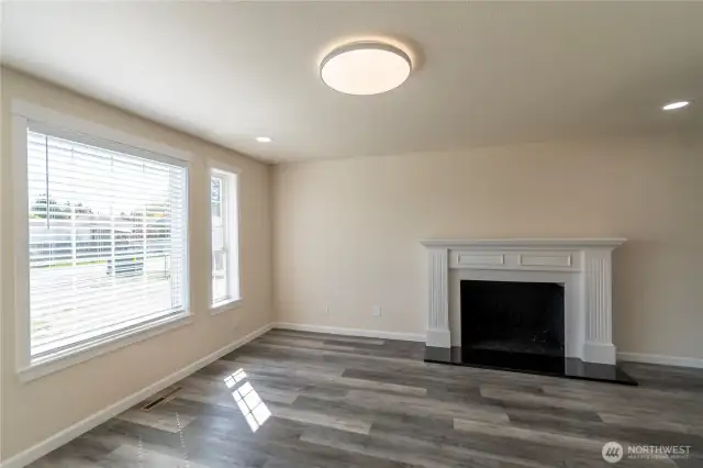 Family room with wood burning fireplace.