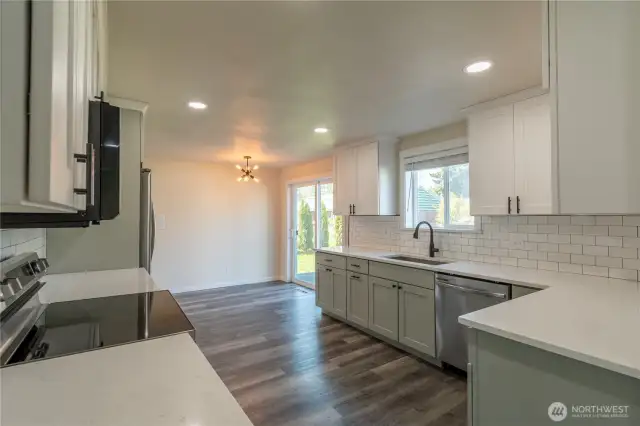 Updated kitchen with granite counter tops, tile backsplash, SS appliances. New flooring throughout the entire home. Home has been nicely updated. Area off kitchen for informal eating. There is also a formal dining area.