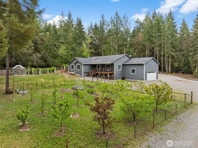 Located just a few short miles from 2 parks, this charming country home has something for everyone.  The outdoors boasts a pool, hot tub, orchard, greenhouse and animal pens.