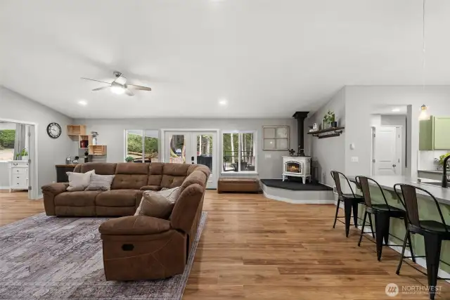 An expansive great room offers a comfortable space to share with your loved ones.  The vaulted ceiling and luxury vinyl plank flooring is both durable and beautiful creating an open airy space.