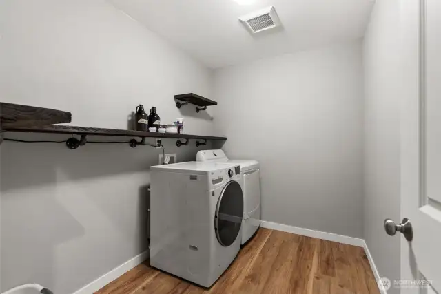 A spacious laundry room provides ample room for a large shelving unit, dog kennel, or craft table. Please note, the washer and dryer are not included with the home.