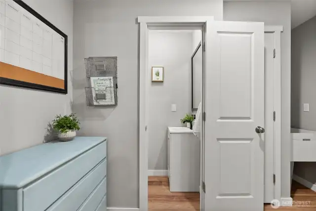 Steps from the kitchen is a powder room and entry from the attached garage.