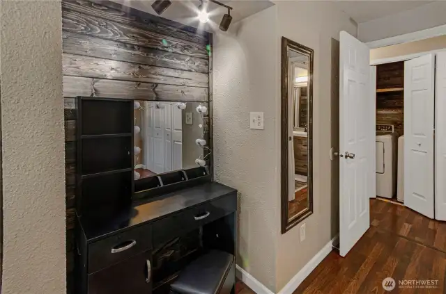Here you get a good glimpse of the alcove in the primary bedroom. How will you use it? Across the hallway is the utility area, enhanced with a wood accent wall. Washer and dryer are included, as are the kitchen appliances. Everything is ready for you!