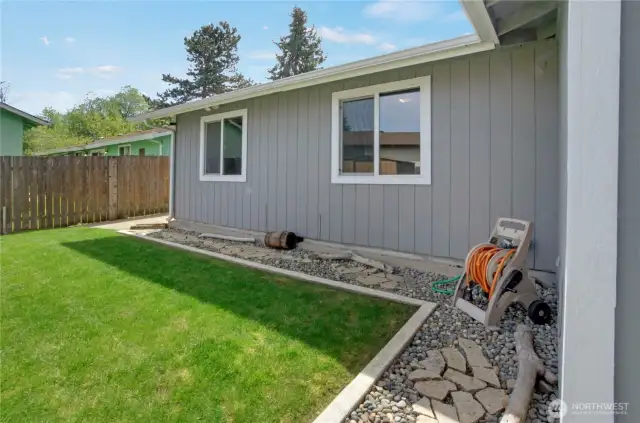 Past the far left corner of the home is the paved area inside the large gate which enters through the side driveway. If you've got a small boat or trailer, or extra vehicle, you'll appreciate the added parking areas.